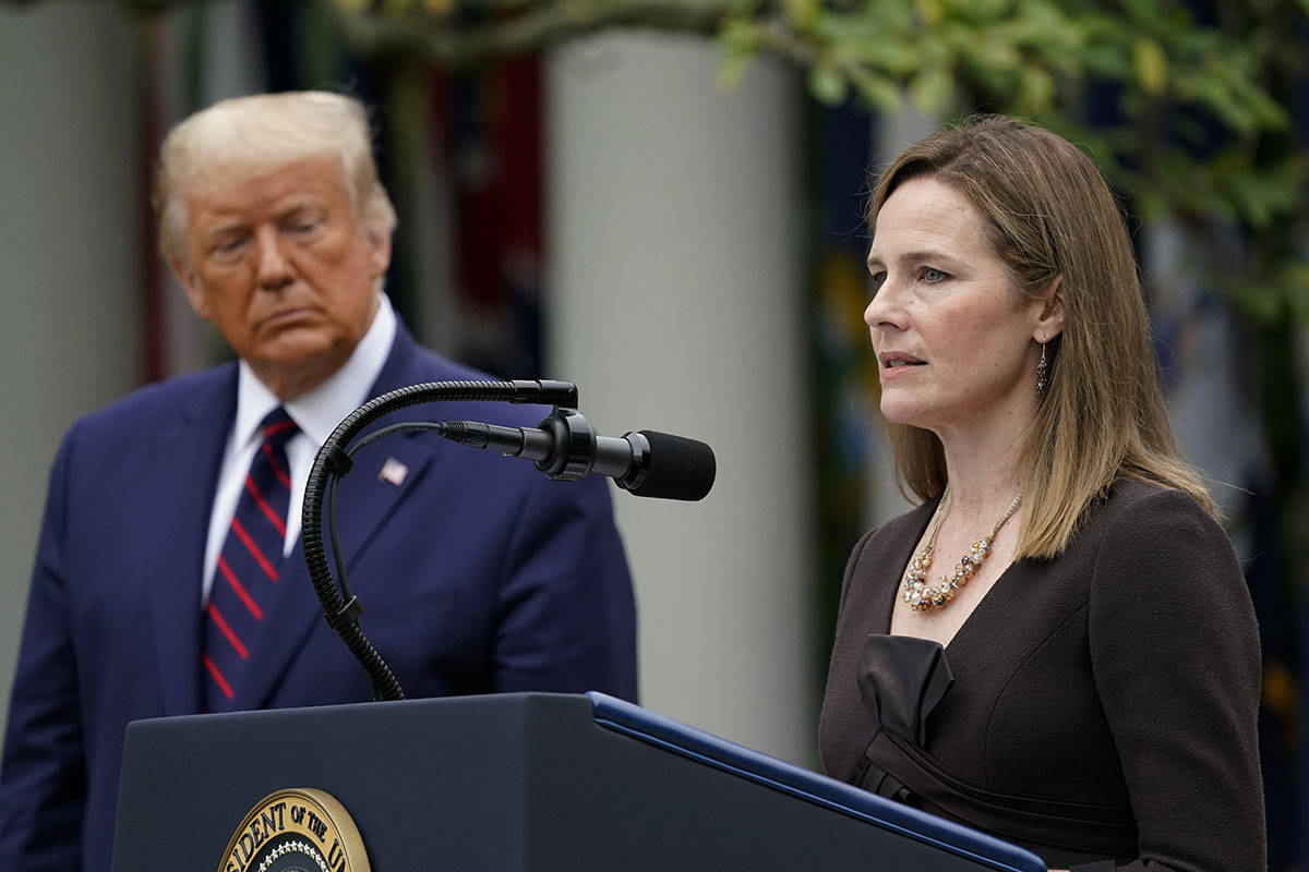 President Donald Trump walks along the Colonnade with Judge Amy Coney Barrett after a news ...