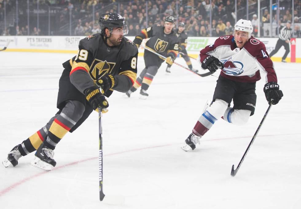 Golden Knights right wing Alex Tuch (89) pushes the puck up ice past Colorado Avalanche defense ...