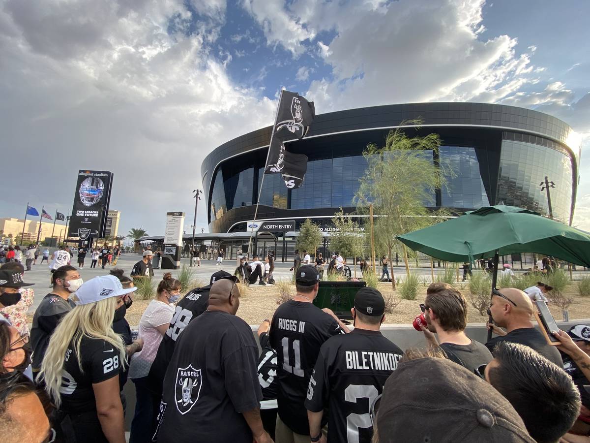 Las Vegas Raiders fans huddled around a 20-inch television on the north end of Allegiant Stadiu ...