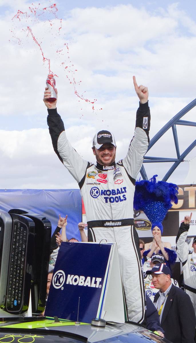 Jimmie Johnson celebrates in victory lane after winning the NASCAR Sprint Cup Series auto race ...