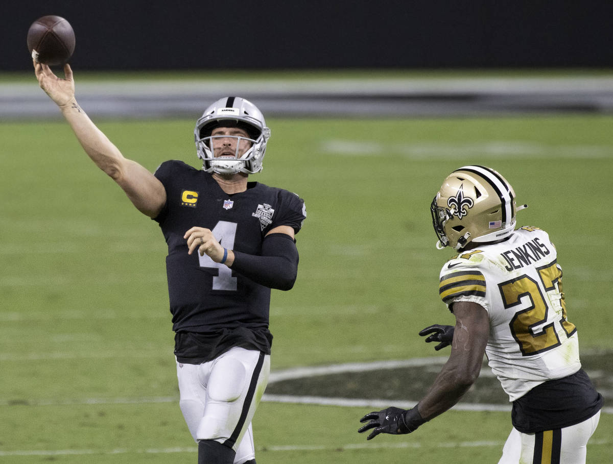 Las Vegas Raiders quarterback Derek Carr (4) makes a running throw over New Orleans Saints stro ...