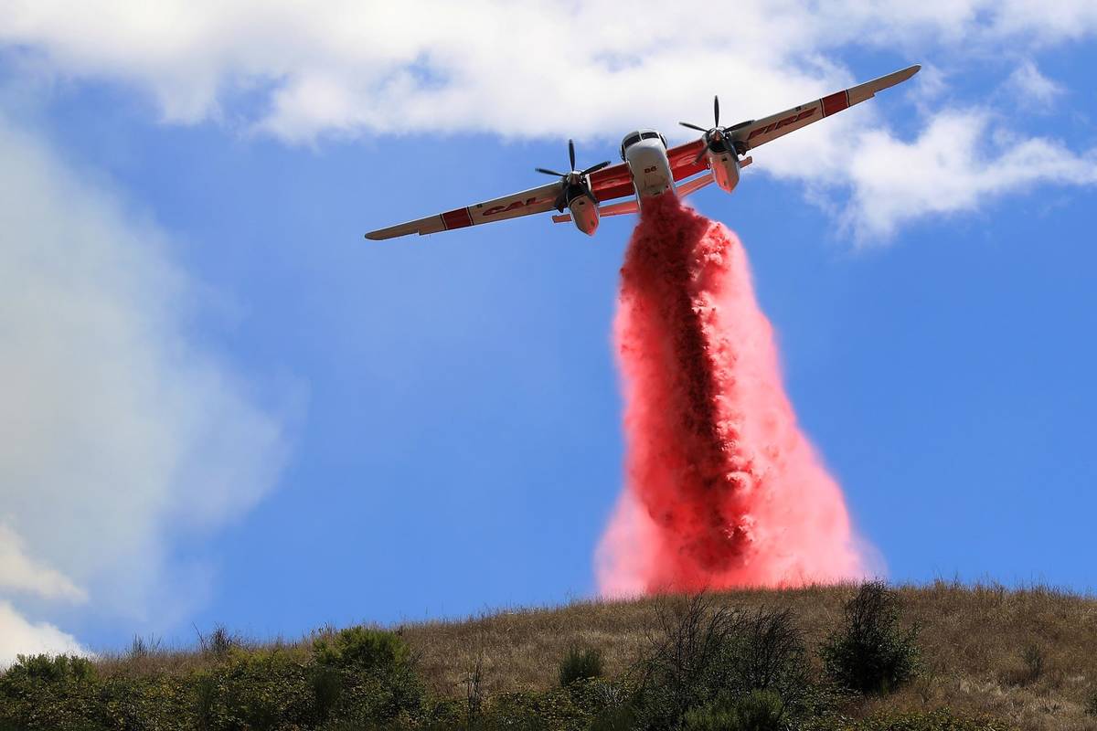 Cal Fire air tankers help stop the spread of a brush fire in Larkfield Calif, Thursday, Sept. 2 ...