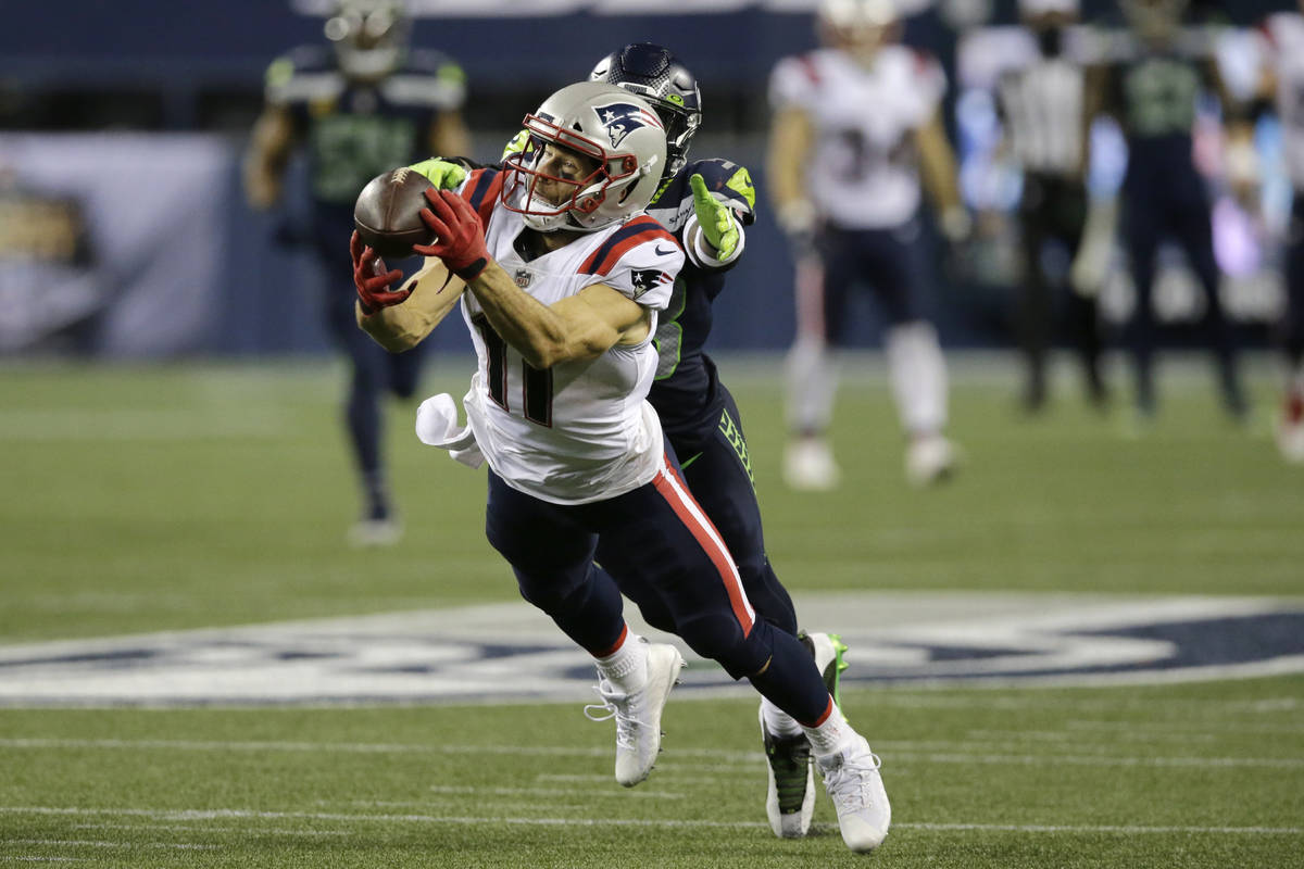 New England Patriots wide receiver Julian Edelman makes a diving catch in front of Seattle Seah ...