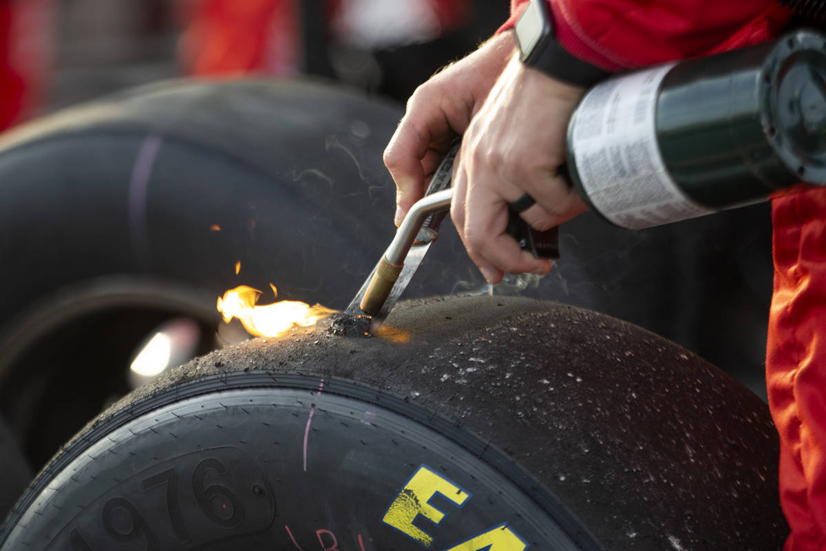 A member of Michael Annett's (1) crew burns rubber off a tire during the NASCAR Xfinity Series ...