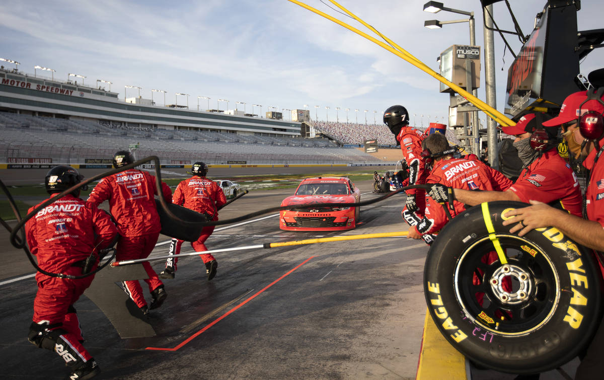 Michael Annett's (1) crew runs out for a pit stop during the NASCAR Xfinity Series auto race at ...