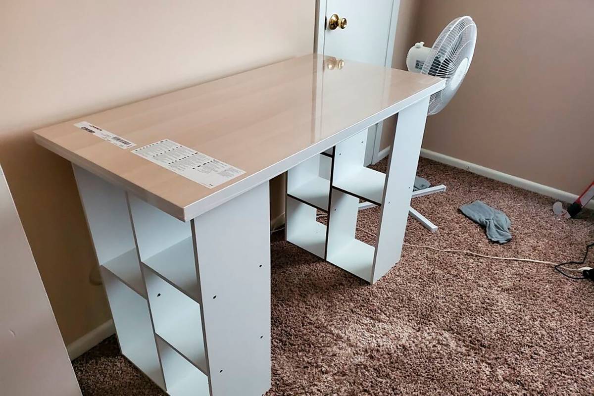 A desk Megan Fry constructed out of a legless tabletop and bookcases stands in her Indianapolis ...