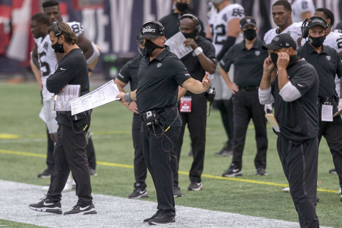 Las Vegas Raiders head coach Jon Gruden, center, reacts as referees review a fumble recovery an ...