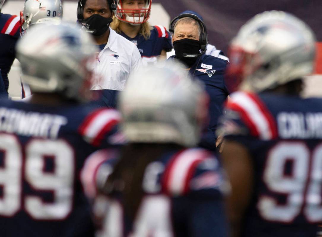 New England Patriots head coach Bill Belichick watches his defense during a time out in the thi ...