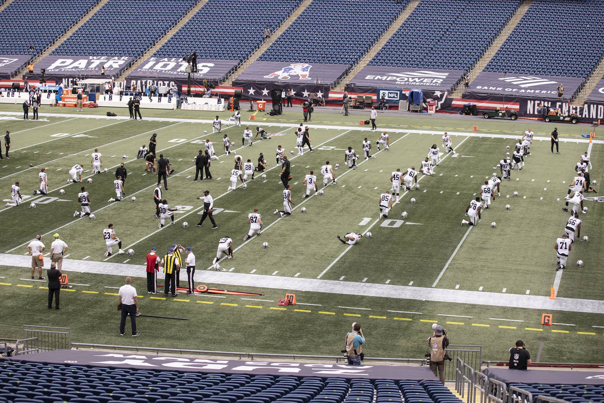 The Las Vegas Raiders warms up before the start of an NFL football game with the New England Pa ...