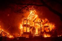 Flames from the Glass Fire consume the Black Rock Inn, late Sunday, Sept. 27, 2020, in St. Hele ...