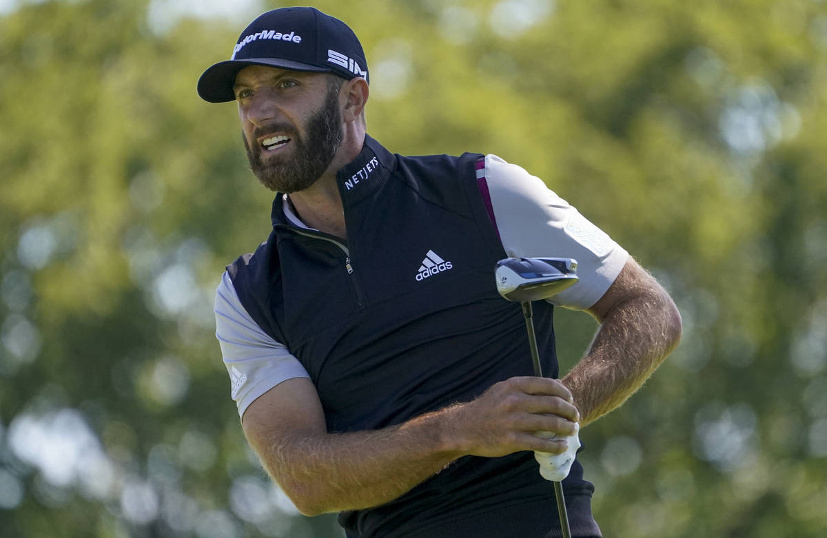Dustin Johnson, of the United States, watches his ball off the fourth tee during the third roun ...
