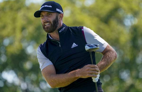 Dustin Johnson, of the United States, watches his ball off the fourth tee during the third roun ...