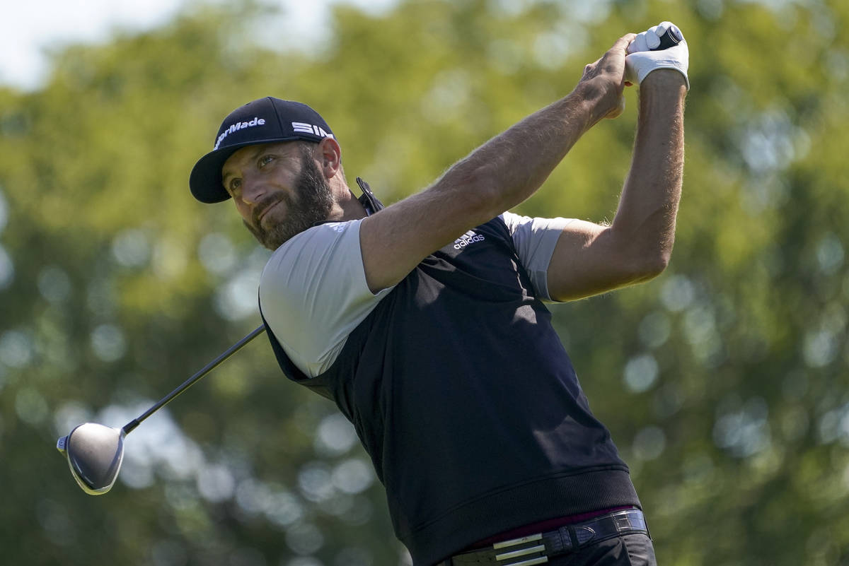 Dustin Johnson, of the United States, plays his shot from the fourth tee during the third round ...