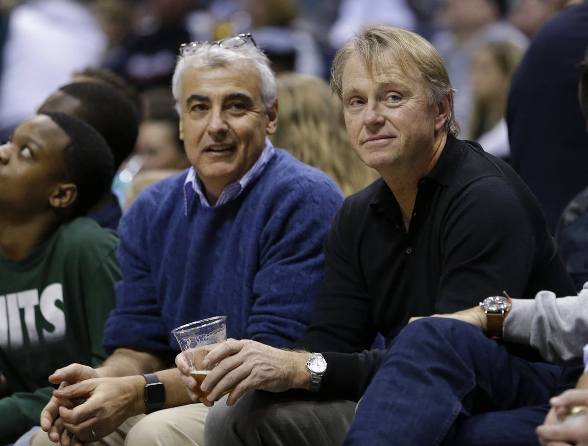 Milwaukee Bucks owners Marc Lasry, left, and Wes Edens, right, watch an NBA basketball game aga ...