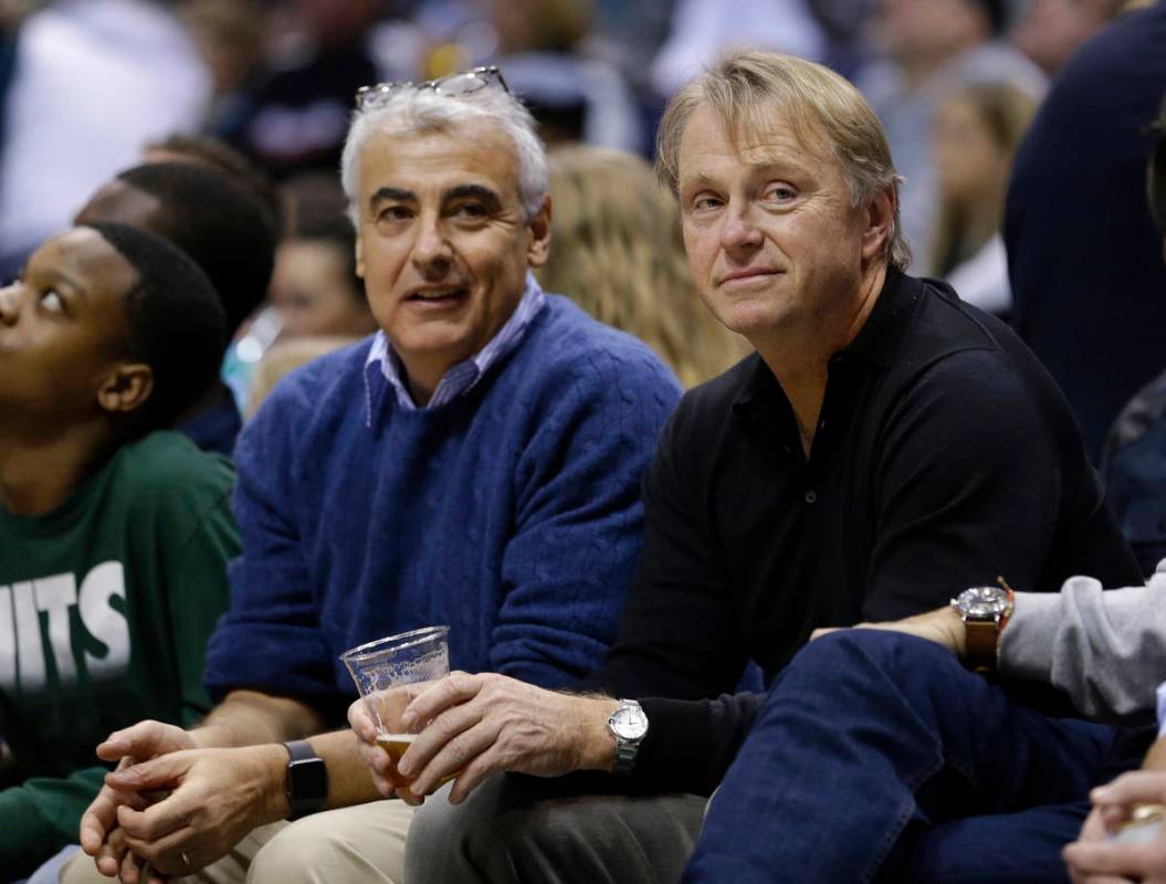 Milwaukee Bucks owners Marc Lasry, left, and Wes Edens, right, watch an NBA basketball game aga ...