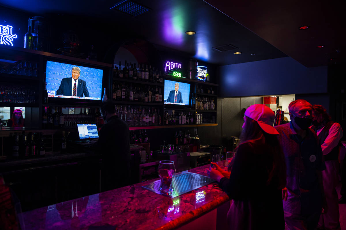 Supporters of President Donald Trump watch while ordering at the bar during a debate watch part ...