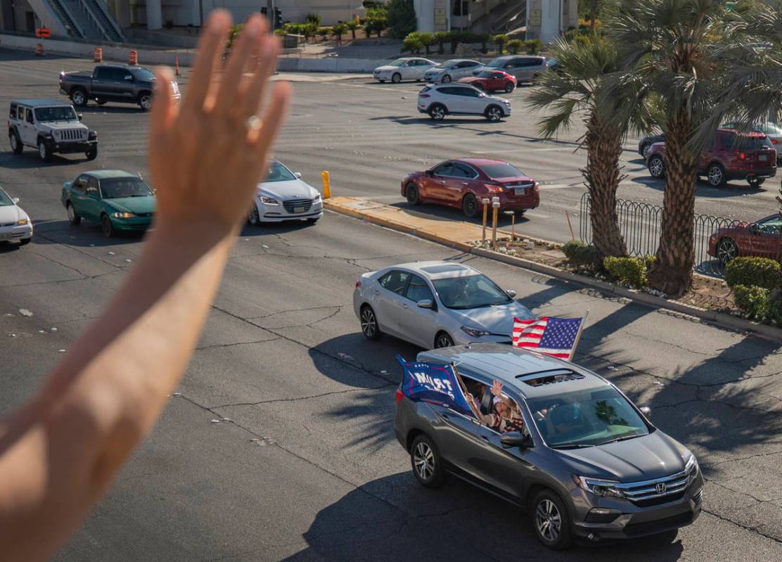 Hope Moore of Rock Hill, South Carolina, waves in support as a caravan of Trump supporters ride ...