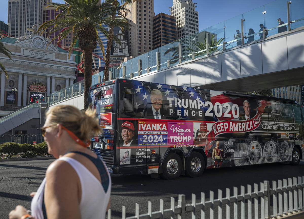 Hope Moore of Rock Hill, South Carolina, is seen while a Trump 2020 bus rides down the Las Vega ...
