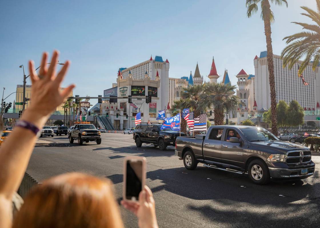 Individuals cheer as a caravan of Trump supporters ride down the Las Vegas Strip, on Wednesday, ...