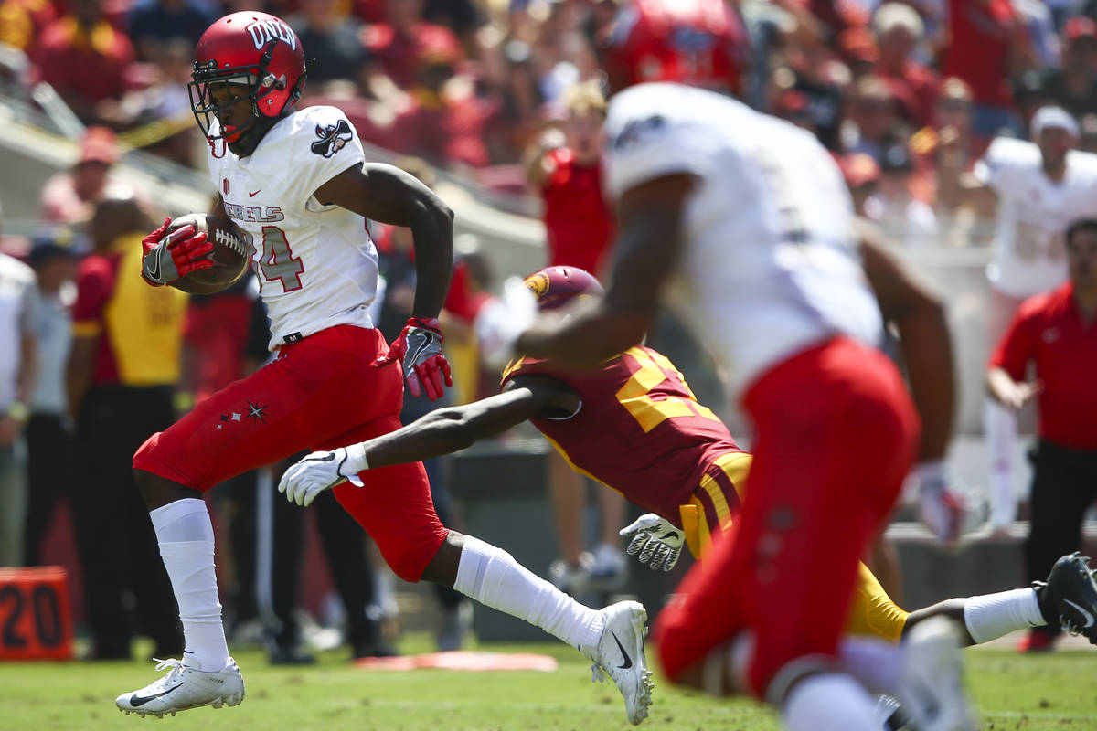 UNLV Rebels wide receiver Kendal Keys (84) avoids a tackle from USC Trojans cornerback Ajene Ha ...