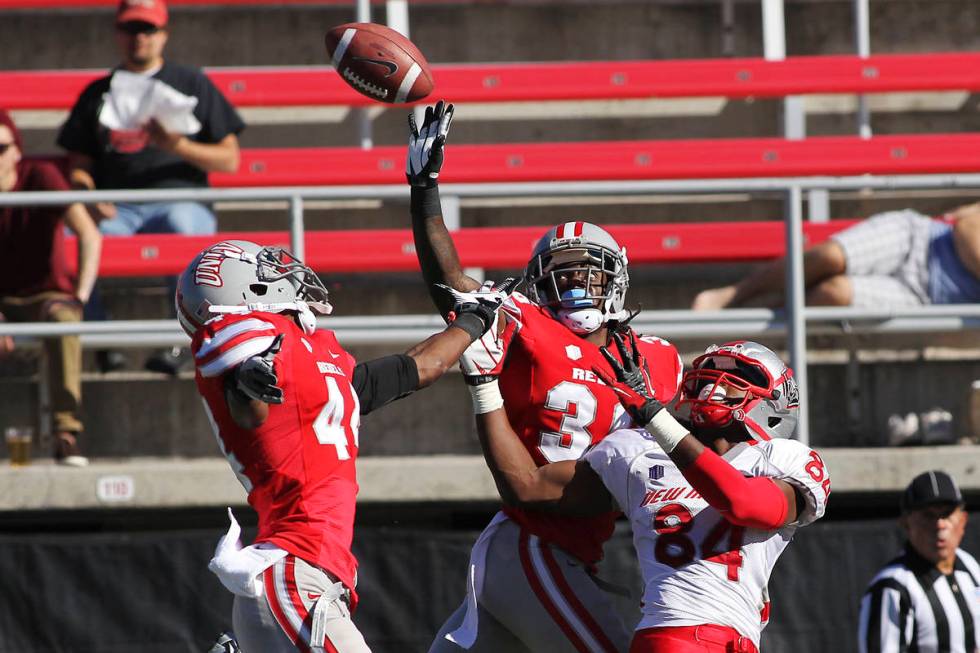 UNLV's Sidney Hodge (36) and Kenny Keys (44) defend a pass intended for New Mexico's Ty Kirk (8 ...