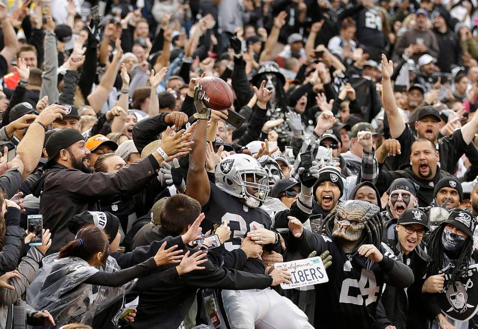 Oakland Raiders running back Jalen Richard (30) celebrates with fans after scoring a touchdown ...