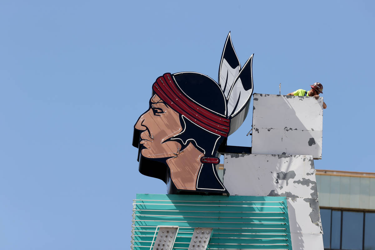 Workers install a new neon addition atop a sign at Hotel Apache at Binion's on Fremont Street a ...