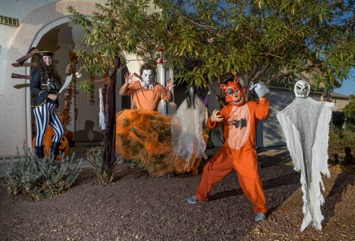 (from right) Alex Montenegro, 8, with parents Joe and Kim Cabrero in costumes with their home d ...