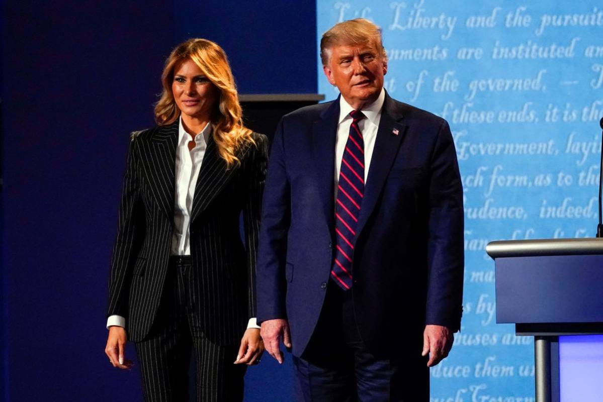 President Donald Trump stands on stage with first lady Melania Trump after the first presidenti ...