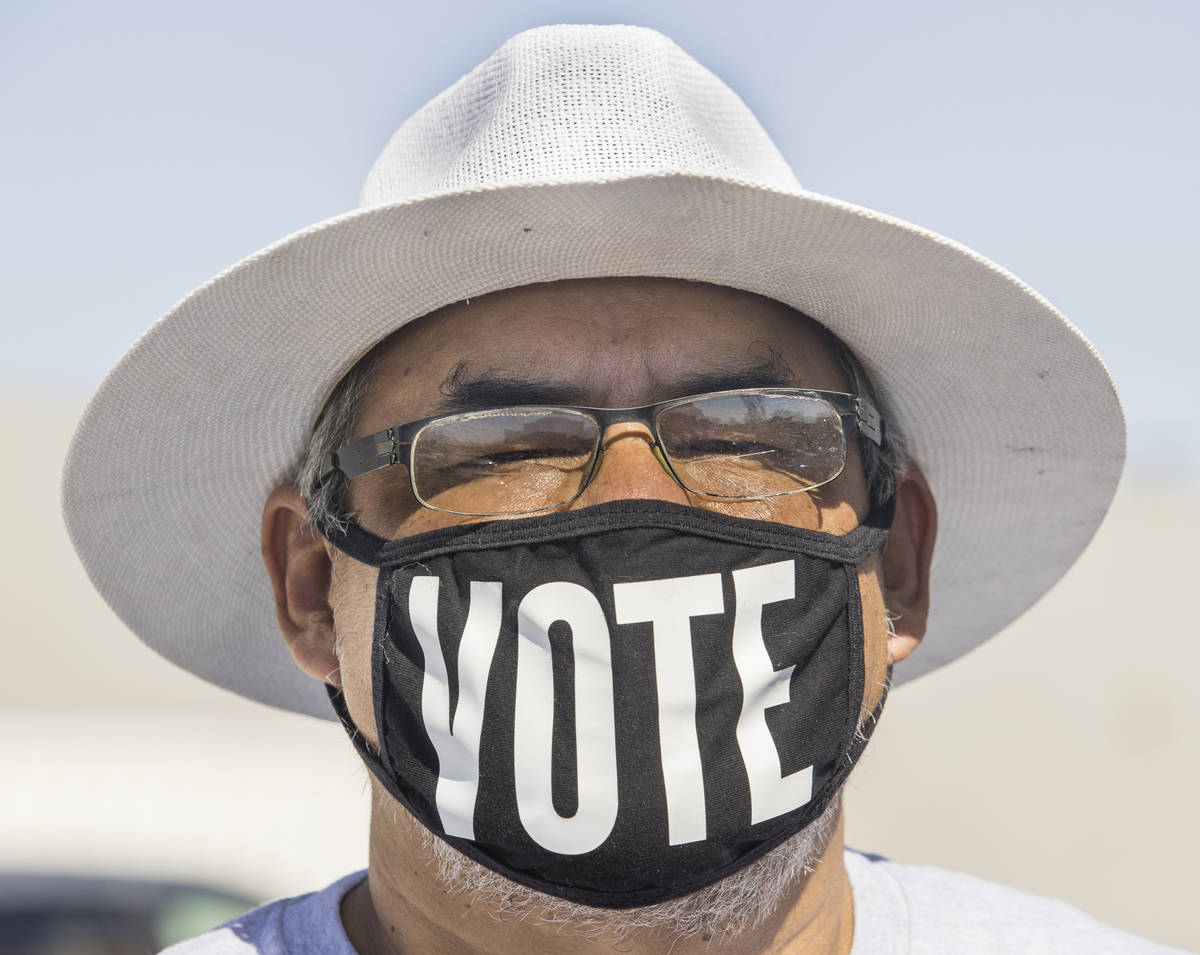 Eddie Ramos sports a ÒvoteÓ mask before Democratic vice presidential nominee Kamala H ...