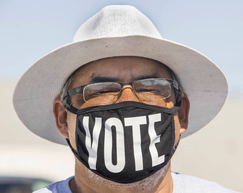 Eddie Ramos sports a ÒvoteÓ mask before Democratic vice presidential nominee Kamala H ...