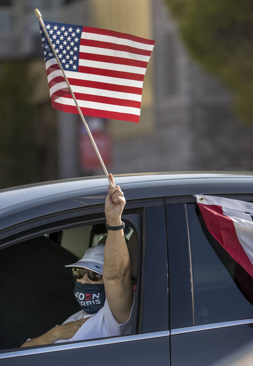 Attendee Rhonda Gambino waves her flag during a drive-in rally for Democratic vice presidential ...