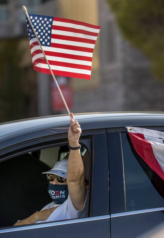 Attendee Rhonda Gambino waves her flag during a drive-in rally for Democratic vice presidential ...