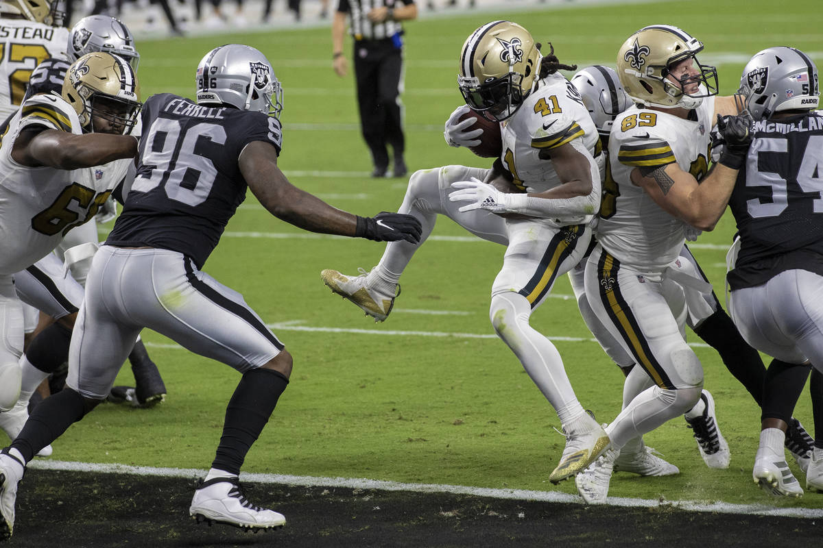 New Orleans Saints running back Alvin Kamara (41) jumps into the end zone past Las Vegas Raider ...