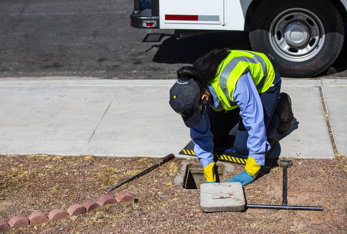 Letty Valenzuela, field technician at Las Vegas Valley Water District, checks on a water meter ...