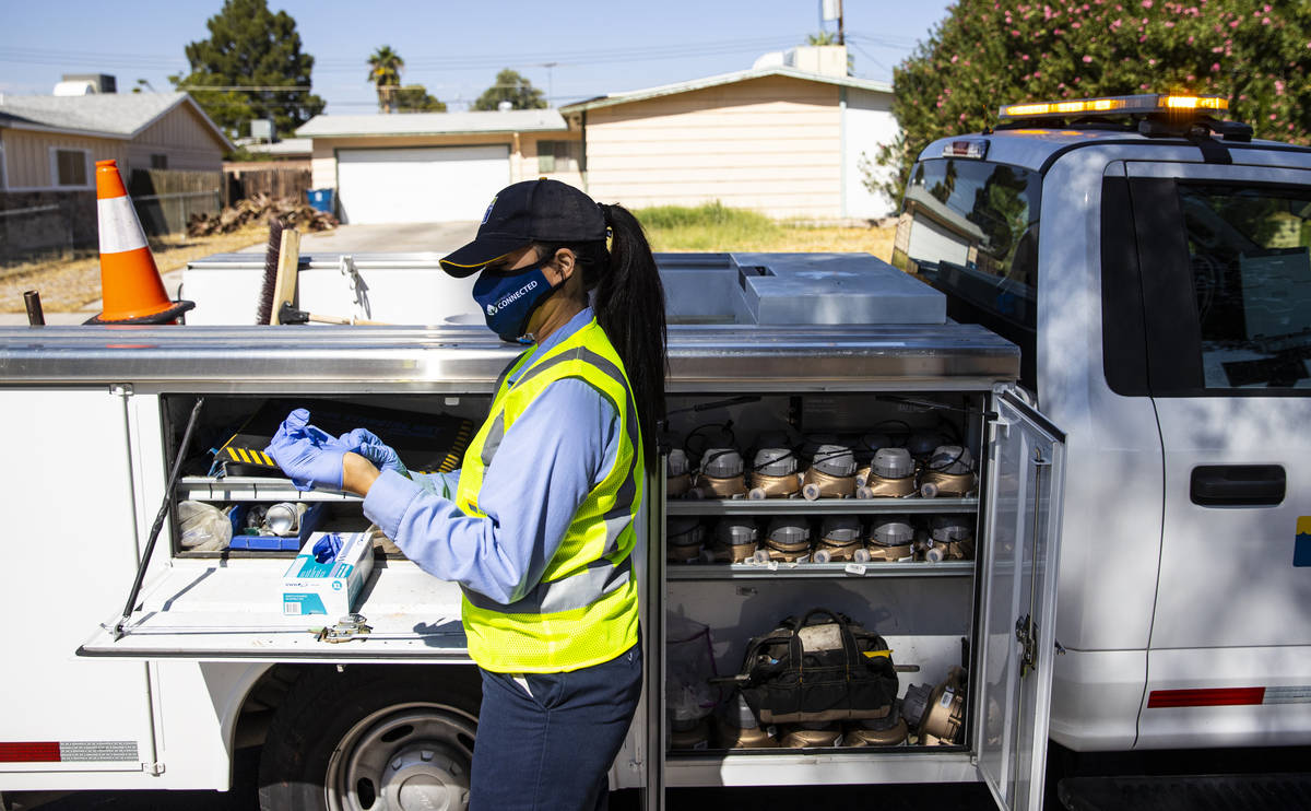 Letty Valenzuela, field technician at Las Vegas Valley Water District, puts on gloves as she ch ...