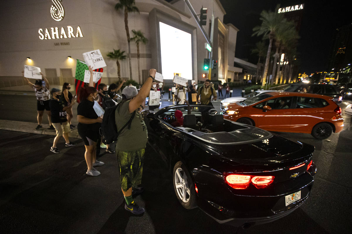 Protesters stop traffic at Sahara Avenue while marching along Las Vegas Boulevard in memory of ...