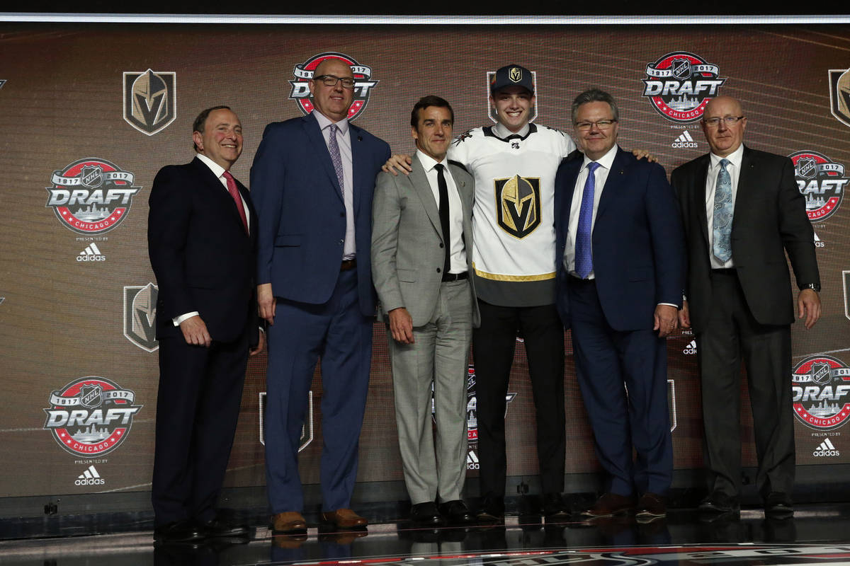 Cody Glass, third from right, wears a Vegas Golden Knights jersey after being selected by the t ...
