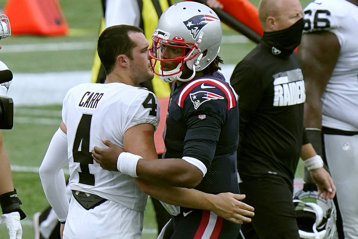 Las Vegas Raiders quarterback Derek Carr, left, and New England Patriots quarterback Cam Newton ...