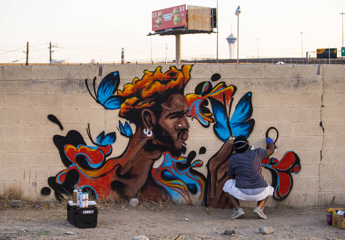 Artist Sloane Siobhan, of Las Vegas, works on a mural called "Butterfly Boy" at the s ...