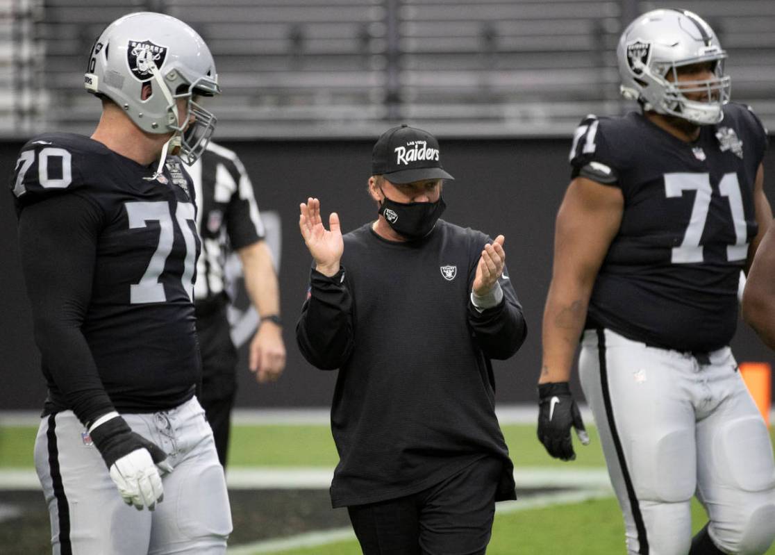 Las Vegas Raiders head coach Jon Gruden, middle, pumps up his team during warms up before the s ...