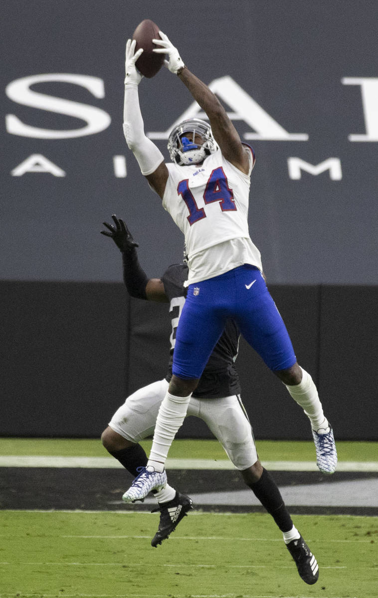 Buffalo Bills wide receiver Stefon Diggs (14) makes a catch over Las Vegas Raiders strong safet ...