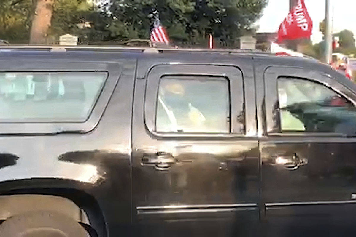 In this image from video, President Donald Trump drives past supporters gathered outside Walter ...