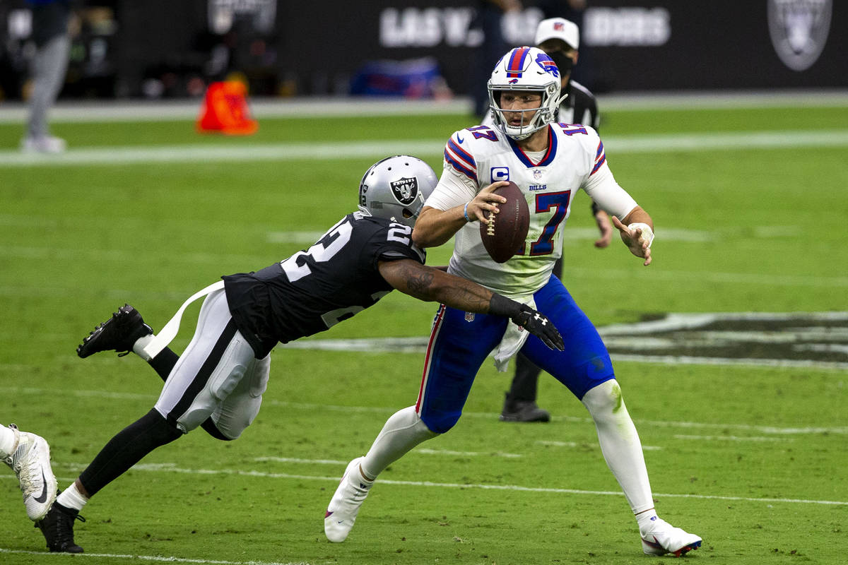 Las Vegas Raiders cornerback Keisean Nixon (22) dives to tackle Buffalo Bills quarterback Josh ...