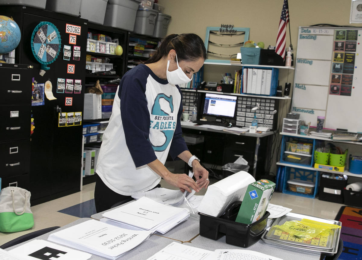 Debbie Martin, second grade teacher, sorts out worksheets at Somerset Academy Sky Pointe as she ...