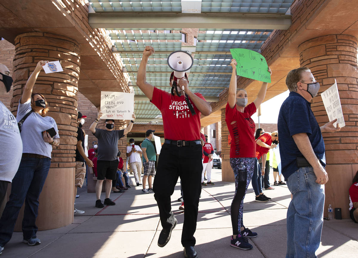 Jose Rivera, center, rally organizer, shouts slogans as he joins a rally outside of the Clark C ...