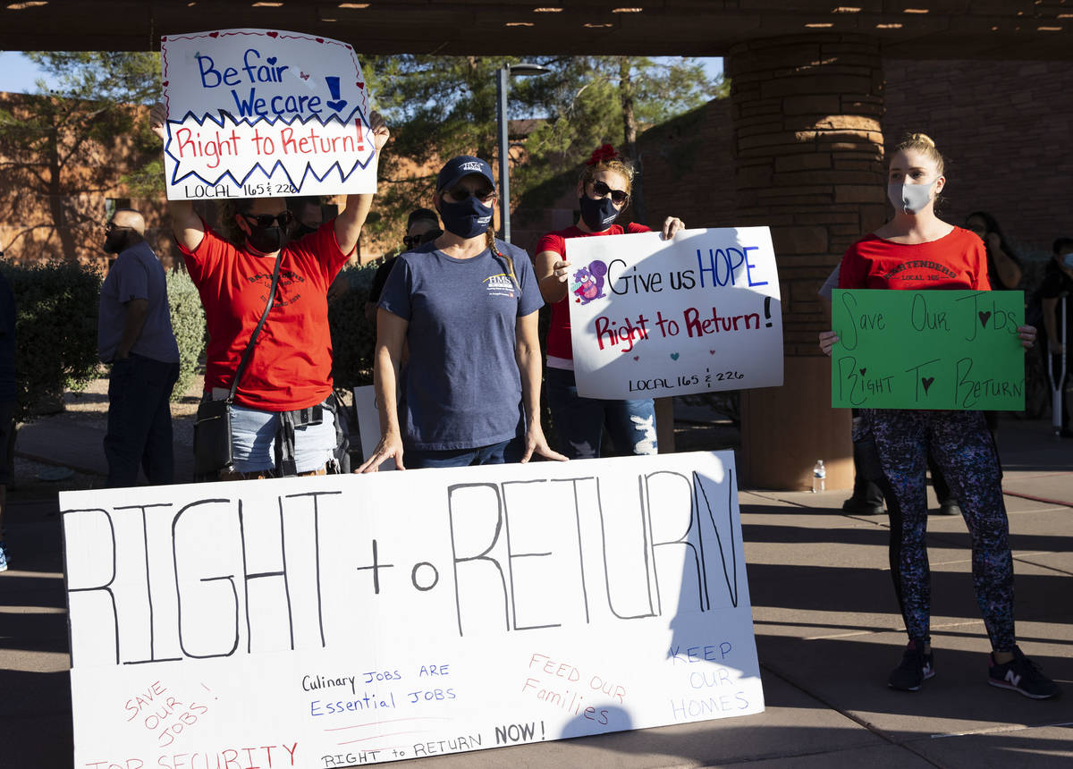 Workers, including Renee Fountain, second left, a worker at HMS Host at McCarran Airpot, rally ...