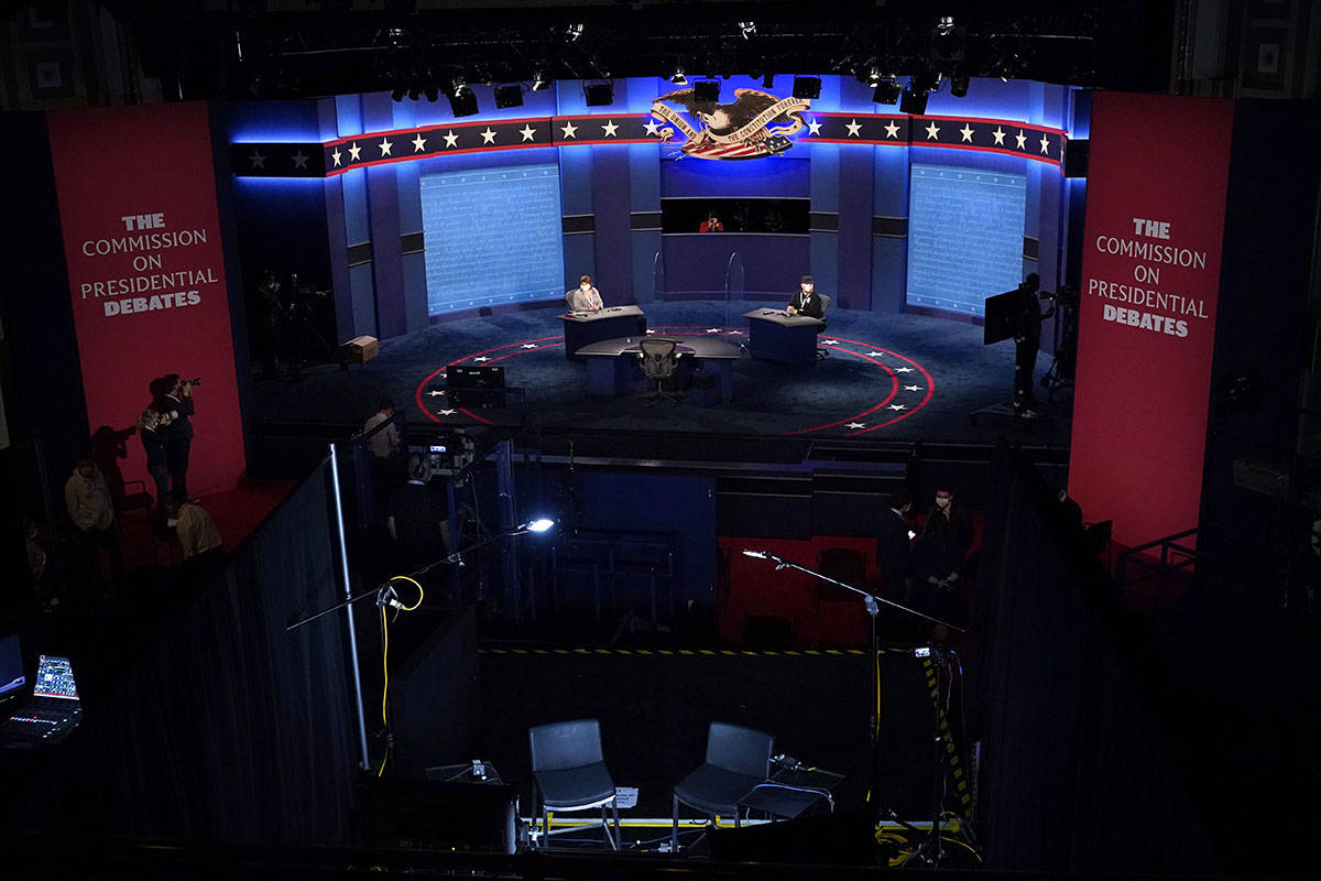 Members of the production crew stand in on the stage near plexiglass barriers which will serve ...
