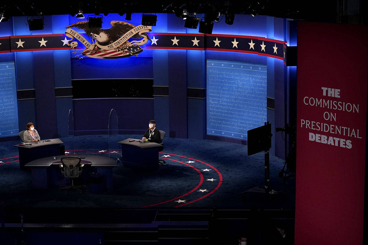 Members of the production crew stand in on the stage near plexiglass barriers which will serve ...