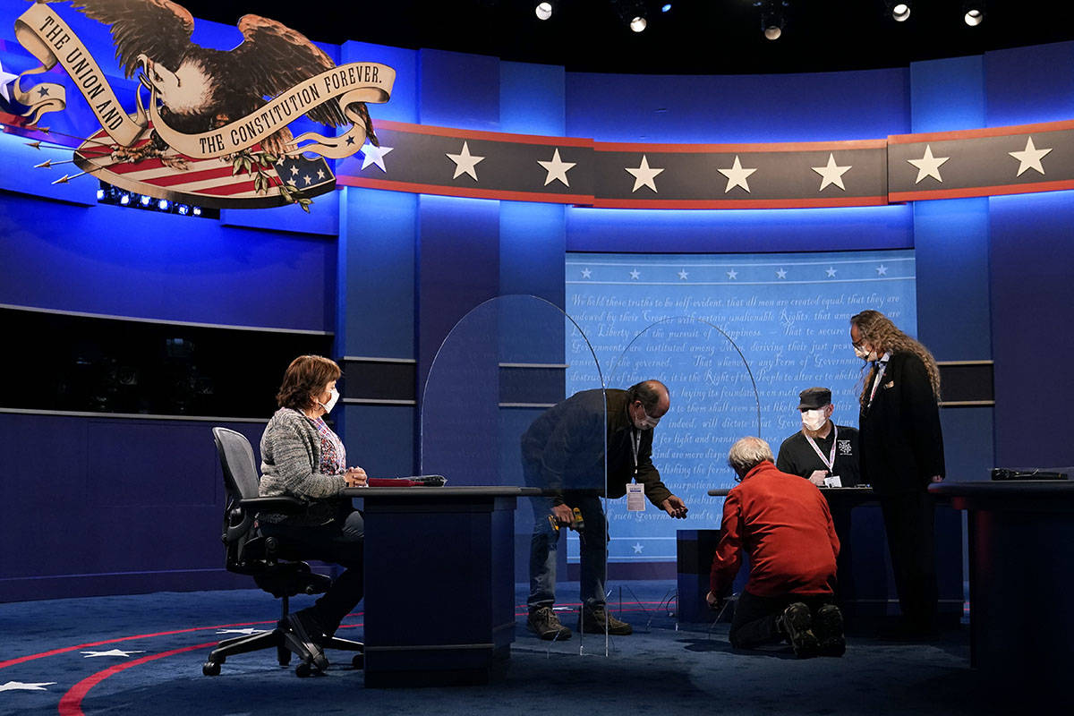 Members of the production crew work on the stage near plexiglass barriers which will serve as a ...